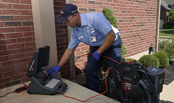 Roto-Rooter plumber analyzing camera inspection