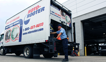 Plumber gathering equipment from service truck