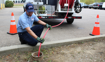 Roto-Rooter plumber cleaning up sewage