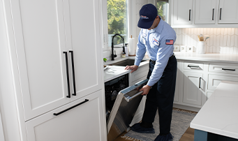 Roto-Rooter Plumber inspecting dishwasher