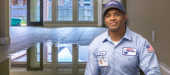 A Roto-Rooter technician standing in front of an emergency flooding situation.