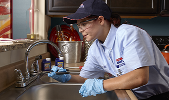 Plumber using plyers to fix drain