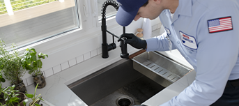 Plumber inspects kitchen sink